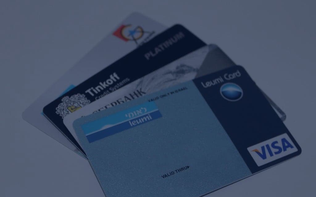 Several generic bank cards on a plain background