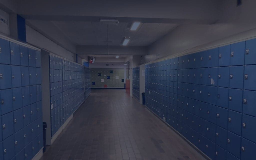 Empty school hallway with blue and green lockers