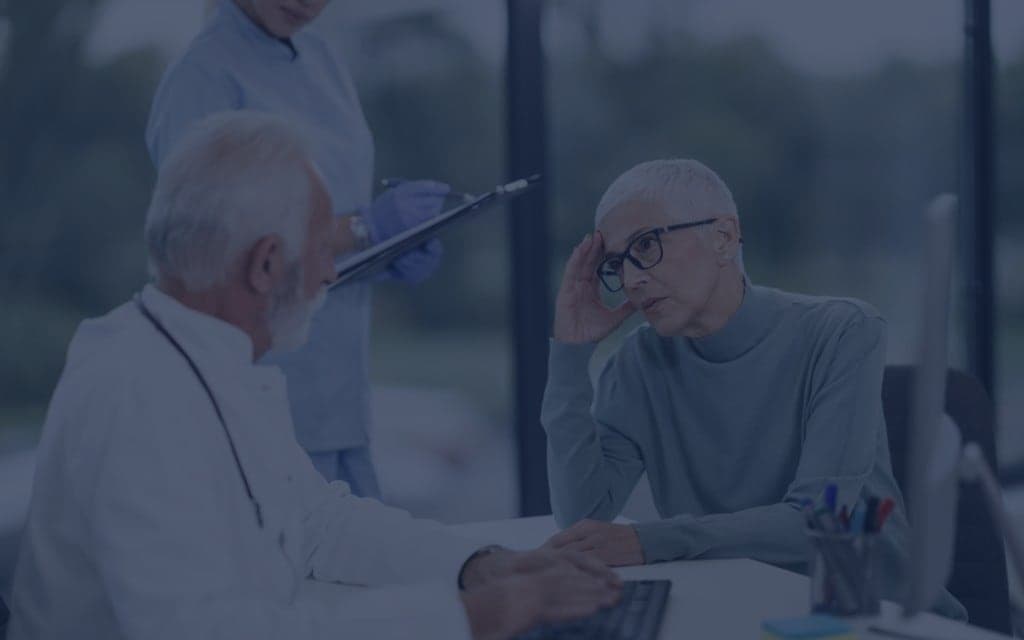 doctor talking to a patient in a hospital setting