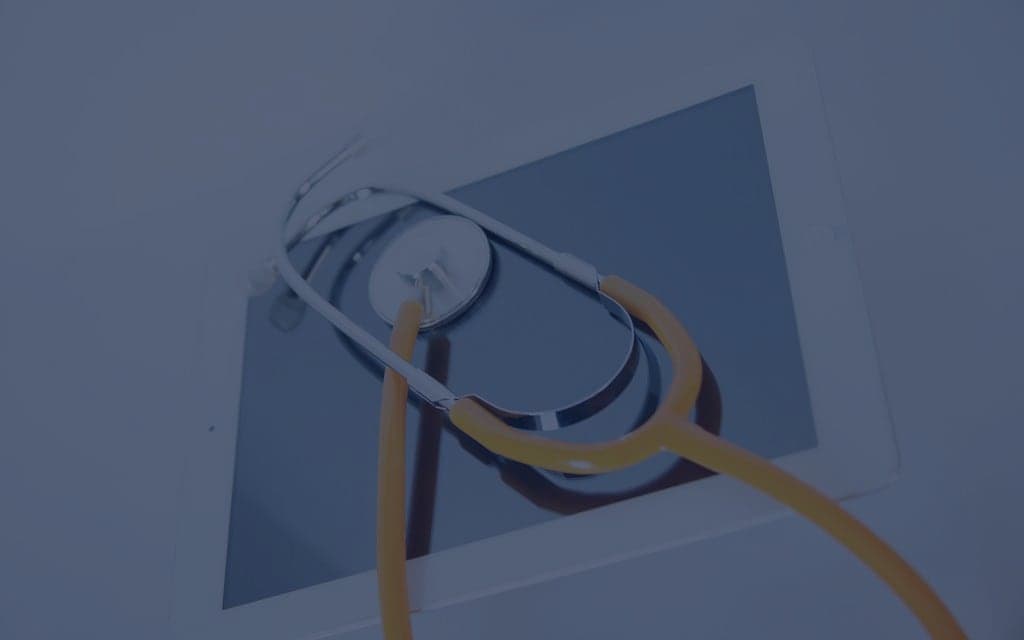 Stethoscope and tablet on a desk
