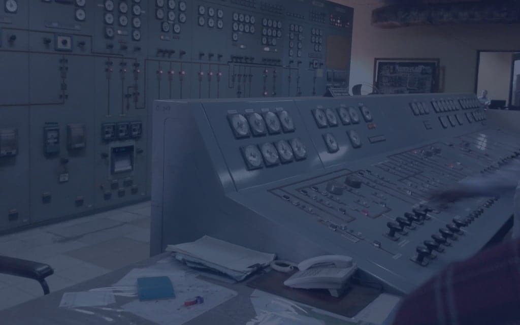 Modern power plant control room with equipment and monitors